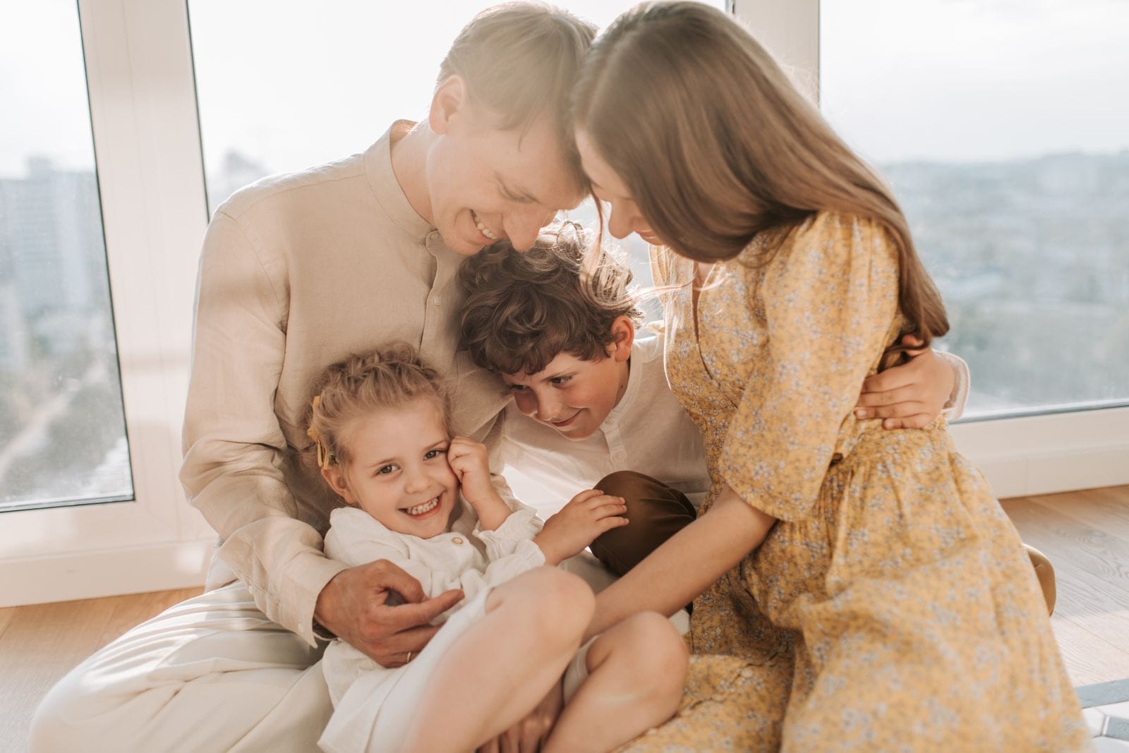 Parents embracing their two children at home